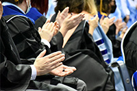Students applauding at a graduation ceremony